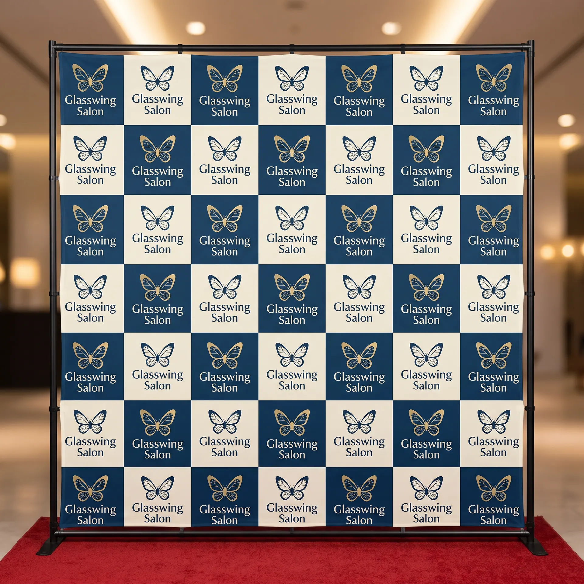 Step-and-repeat backdrop: a printed fabric graphic stretched on a tube frame, shown with a sample design: at a gala photo wall with soft event lighting and a short red carpet